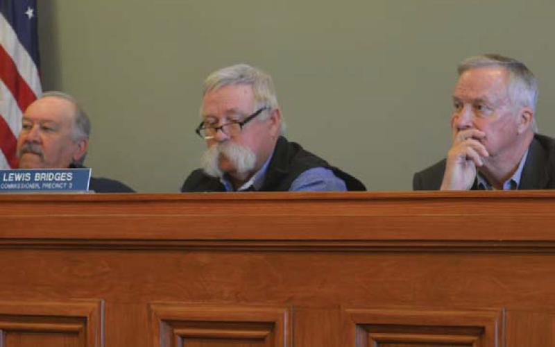 Commissioners Court members, from left to right, Precinct 4 Commissioner Mark Rainwater, Precinct 3 Commissioner Lewis Bridges and County Judge Randy Hoyer listen to comments during Monday’s meeting. erick mitchell | dispatch record