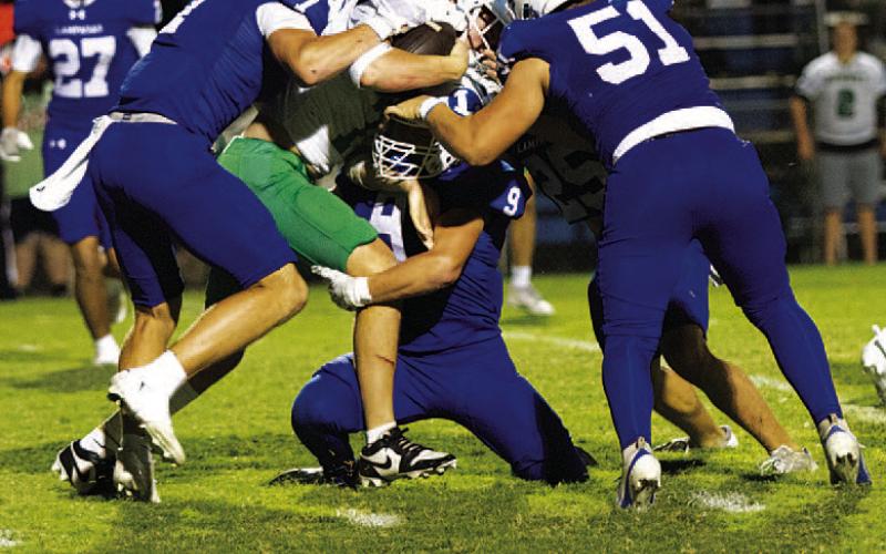 Four Badgers are in on the tackle of the Burnet ball carrier last week. HUNTER KING | DISPATCH RECORD