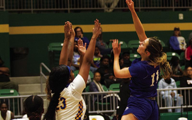 HUNTER KING | DISPATCH RECORD Mia Mulcahy shoots over two Lady Pirate defenders.