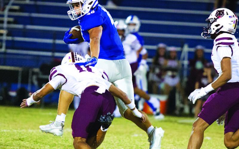 HUNTER KING | DISPATCH RECORD Haeagan Oncken makes a Davenport tackler miss as he runs up the middle of the field.