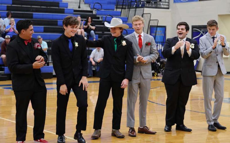 Brock Langford places a hand on the back of this year’s LHS Prom King Trent Seneca while the other nominees, Preston Isom, Dillon DuVall, Keaton Black and Benjamin Ybarra, clap to congratulate their colleague. JOYCESARAH MCCABE | DISPATCH RECORD