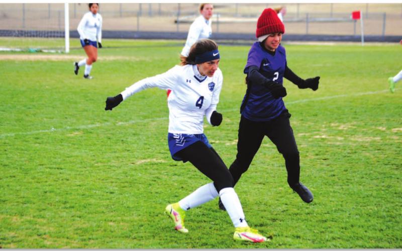 Nyla Long plays a ball down the line to a teammate during the Lady Badgers’ win over Florence last Friday. Long also scored a goal in the match. HUNTER KING | DISPATCH RECORD