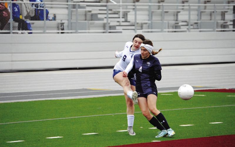 Bella Lindsey whips in a cross in front of a defender. She was one of the two goal scorers on Tuesday. HUNTER KING | DISPATCH RECORD