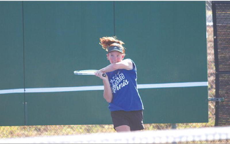 Allison Valdez swings through a backhand during the tennis team’s dominant win over Glen Rose. HUNTER KING | DISPATCH RECORD
