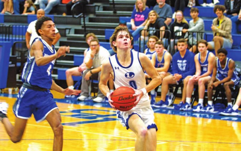 Nate Borchardt goes to the rim for a layup against Whitney in the same game he scored his 1,500th career point for the Badgers. HUNTER KING | DISPATCH RECORD