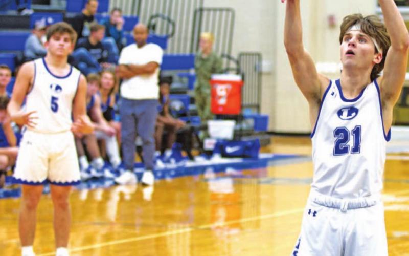 Austin Wilson follows through on a free-throw attempt against Whitney in a previous game. Dax Brookreson is also pictured during the big win. HUNTER KING | DISPATCH RECORD
