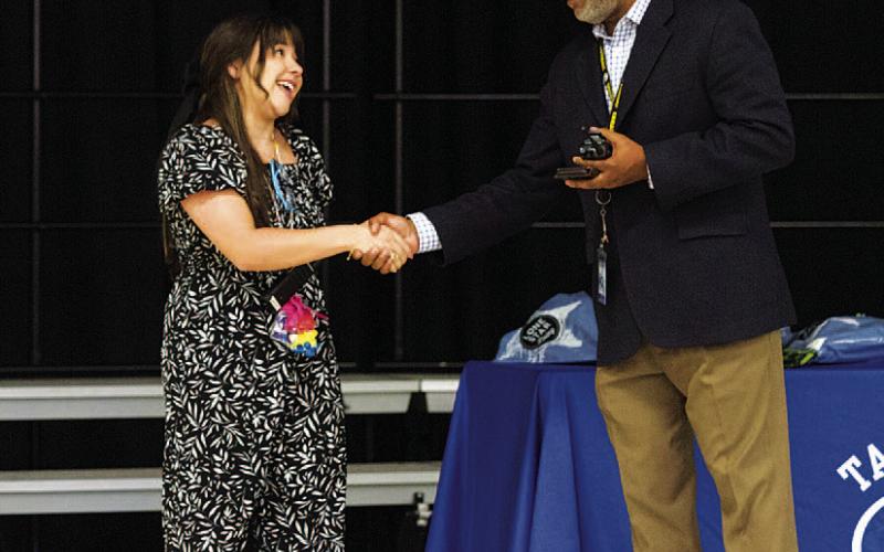 Monica Garza shakes the hand of Sheppard after being recognized as a finalist for the teacher of the year award. All the students at Taylor Creek were in attendance at the special event to applaud their teachers. HUNTER KING | DISPATCH RECORD