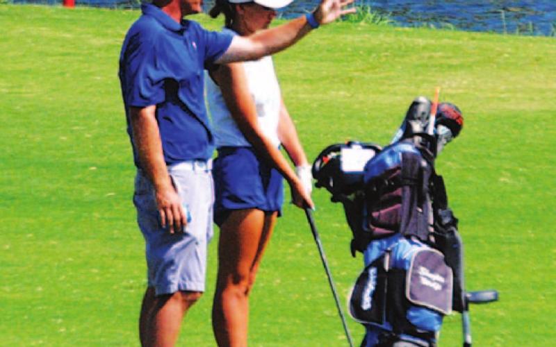 Head coach Justin Schulze talks about a shot with Shaylee Wolfe. HUNTER KING | DISPATCH RECORD