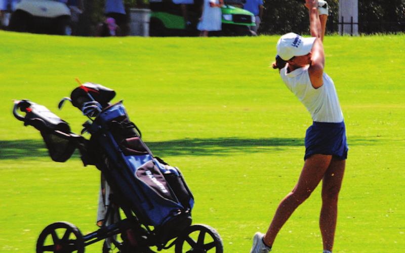 Shaylee Wolfe finishes on a shot from the fairway on the 12th hole at Legends Golf Course in Kingsland. HUNTER KING | DISPATCH RECORD