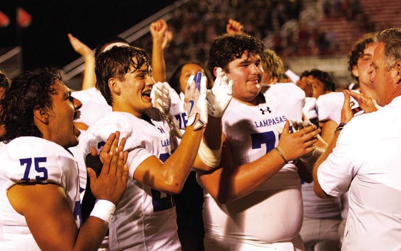 Colter Sellers, middle, and his teammates clap up a win over the Leopards following the game. HUNTER KING | DISPATCH RECORD