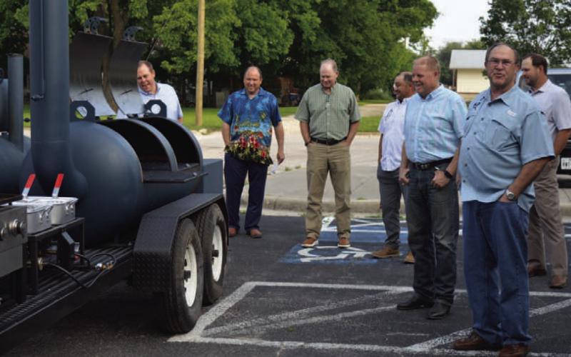 Creating Badger Builders members show the LISD Board of Trustees and other district officials the new smoker trailer the group donated to the high school’s culinary department earlier this year. ERICK MITCHELL | DISPATCH RECORD