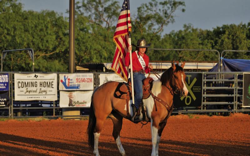 Rodeo Queen Hadyn Ferguson presents the American flag to the rodeo crowd. ERICK MITCHELL | DISPATCH RECORD