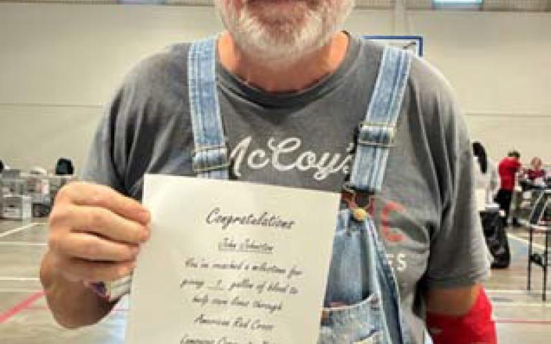 John Johnston poses with his certificate after achieving the 1-gallon mlestone. COURTESY PHOTO