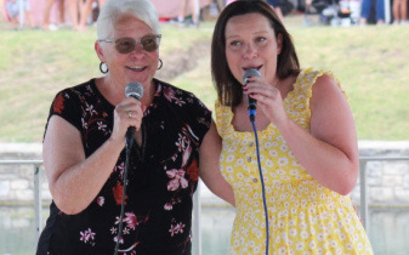 joycesarah mccabe | dispatch record Mother-daughter duo with Connie Barham, left, and Jaci Barham entertain those gathered to listen to music in W.M. Brook Park during Spring Ho activities.