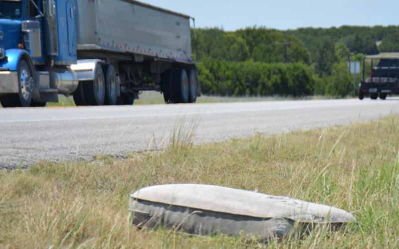 A discarded mattress sits in the grass beside U.S. Highway 183/U.S. Highway 190 between Lampasas and Lometa. County roads also have experienced illegal dumping in several areas, according to members of the Lampasas County Commissioners Court. MONIQUE BRAND | DISPATCH RECORD