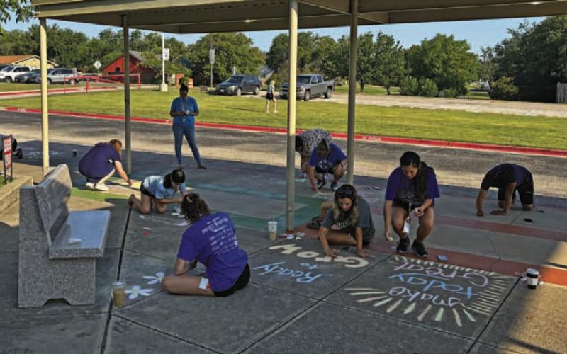 Kline Whitis Elementary School staff chalks up the entryway to the campus on Wednesday before the first day of school on Thursday. COURTESY PHOTO