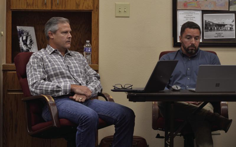 At left, Justin Huling of American Constructors, the district’s construction manager at risk for the bond project, and WRA Architect’s Justin Bell provided feedback to school board members during Monday’s called meeting. ERICK MITCHELL | DISPATCH RECORD