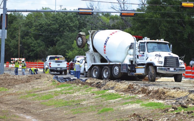 TxDOT contractors work near the Lampasas High School entrance on Thursday afternoon. ERICK MITCHELL | DISPATCH RECORD