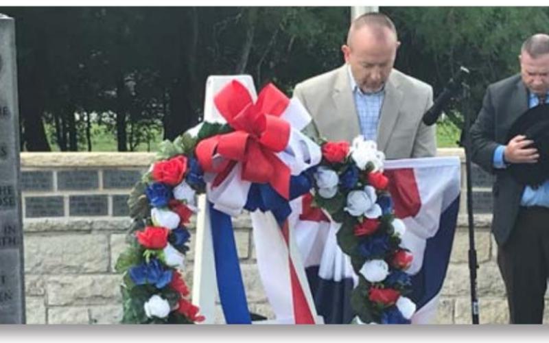 Chaplain Bryan Flatt, with the Texas State FOP Lodge, offered a prayer during a Memorial Day event Monday in Kempner. Behind him is Mayor John Wilkerson. MONIQUE BRAND | DISPATCH RECORD