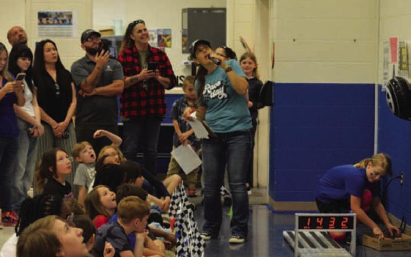 Students and parents look at the “lap” times to see which car took took the checkered flag. ERICK MITCHELL | DISPATCH RECORD