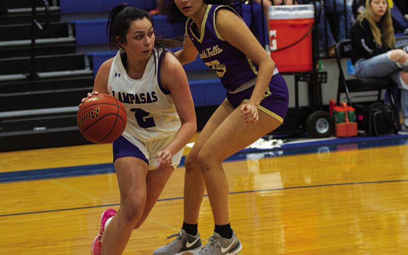 Johnnie Lewis looks for a teammate to pass to as she drives the baseline. HUNTER KING | DISPATCH RECORD