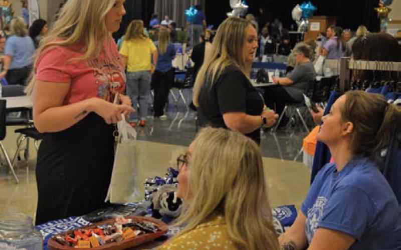 LISD employees connect with Badger Tracks Custom representatives during the Back to School Bash event at the Lampasas High School campus. erick mitchell | dispatch record