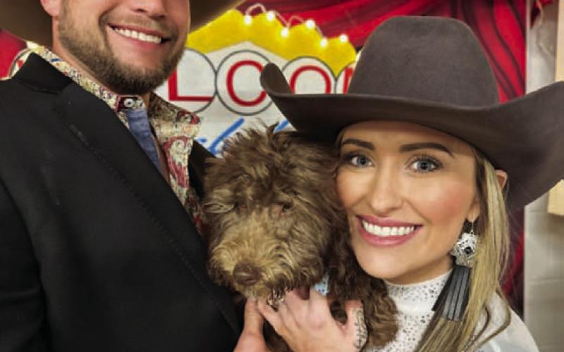 Amanda Bowen, right, was the top bidder in the puppy auction at Saturday’s Wild West Casino Night. She and her husband took home the cuddly animal at the end of the event. STEPHANIE FITZHARRIS | COURTESY PHOTO