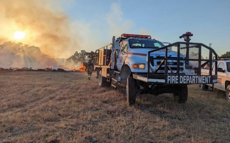 Flames stretch upward as volunteer firefighters work to stop the Spotted Opossum Fire from spreading and extinguish the flames. sharon watson | courtesy photo