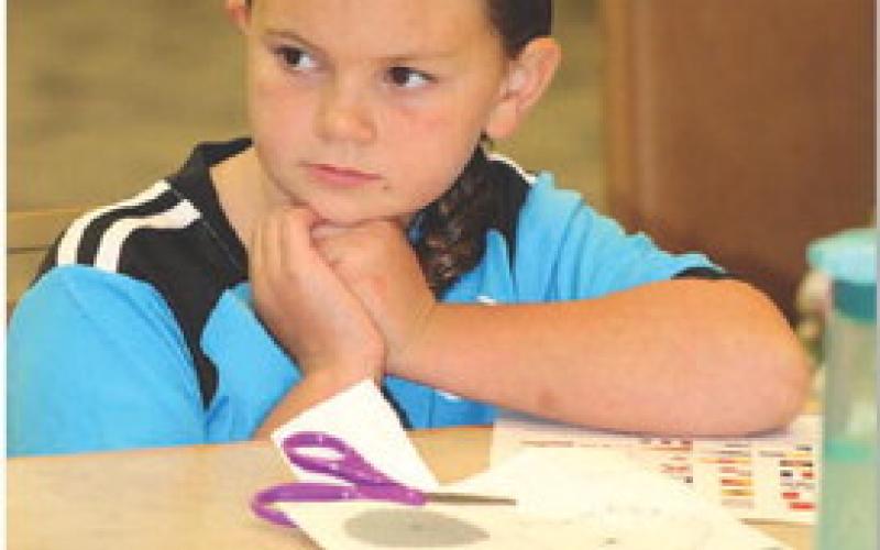 JOYCESARAH MCCABE | DISPATCH RECORD Chloe Phillips, 7, thoughtfully considers her plan for creating a pirate ship. Tuesday was her first time to attend one of the Lampasas Public Library’s STEAM events. The 10 a.m. event hosted about 18 area homeschoolers.