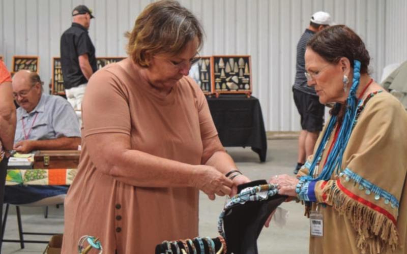 A jewelry vendor assists a customer at a previous Indian Artifact, Gem and Mineral Show. This year, the entrance fee to the show also allows admittance to Merritt Romans’ rock and mineral museum in downtown Lampasas. FILE PHOTO