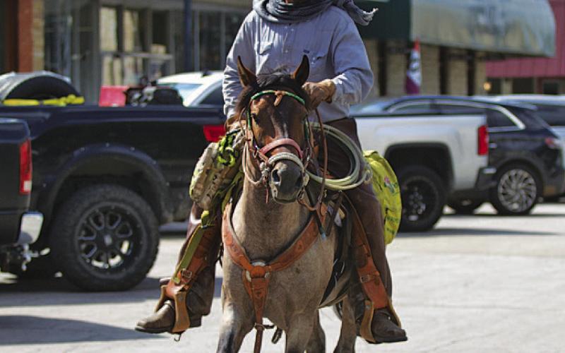 Jeremy Robinson rides his horse Trooper through downtown Lampasas on Wednesday. Robinson is nearing the end of a trek across Texas to raise awareness about veteran homelessness. His ultimate goal is to build a homestead and equine center where veterans could stay as long as needed, grow their own food and experience the “brotherhood” with others they experienced while in the military. HUNTER KING | DISPATCH RECORD