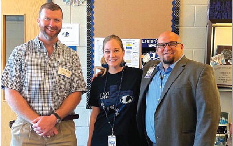 COURTESY PHOTO Clay Phillips of Texas Farm Bureau Insurance, at left, and Assistant Principal Ryan Race are shown with Alisa Preece, who was named the Lampasas High School Paraprofessional of the Month for August. “Mrs. Preece is one of the hardest-working people we have ever met,” Race said. “She is a quiet leader who is up to any task.” Preece serves as the athletics secretary.