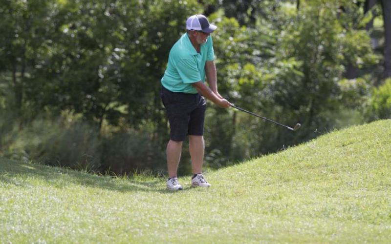 A competitor follows through on a chip shot during the afternoon event at Hancock Park Golf Course on Saturday. HUNTER KING | DISPATCH RECORD
