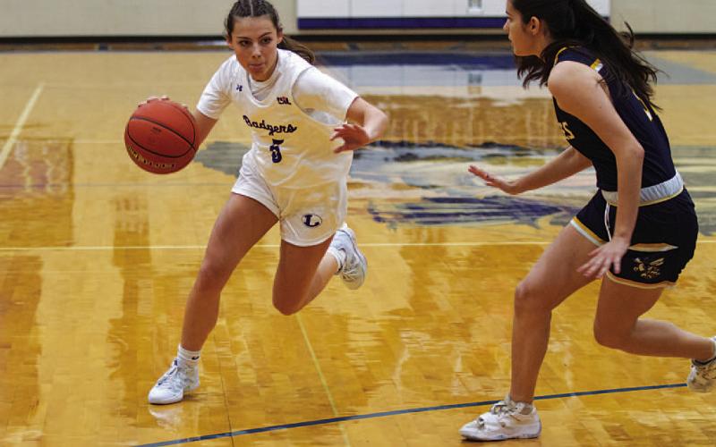 HUNTER KING | DISPATCH RECORD Chloe Thorp drives past a Stephenville defender in the first half of the Lady Badgers’ game.