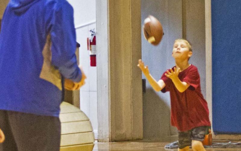 Football camp draws big turnout despite rain