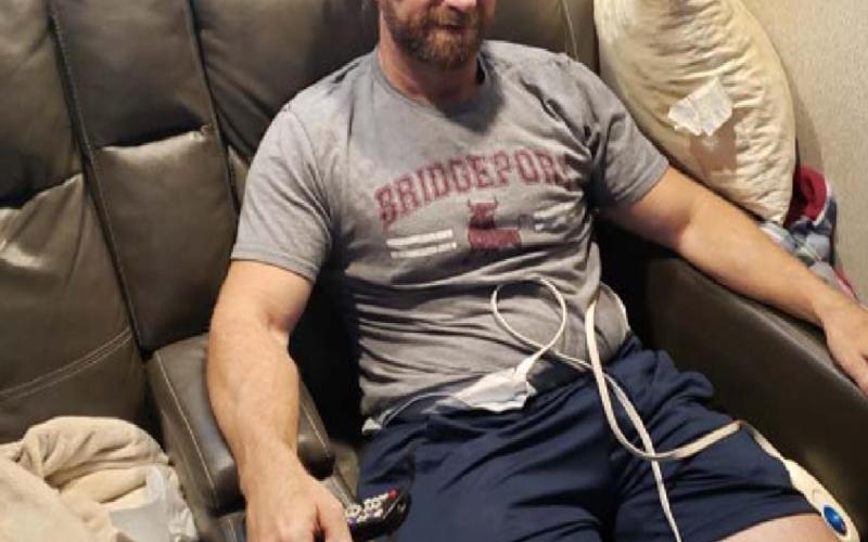 Chris Murrell treats his headache with a cold compress and his joint aches with heating pads during the throes of his COVID-19 infection. ALEXANDRIA RANDOLPH MURRELL | DISPATCH RECORD
