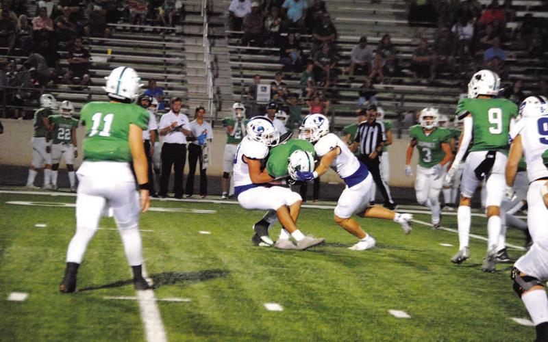 HUNTER KING | DISPATCH RECORD Raider Morua, left, and Reed Jerome team up on a tackle for loss against Burnet.