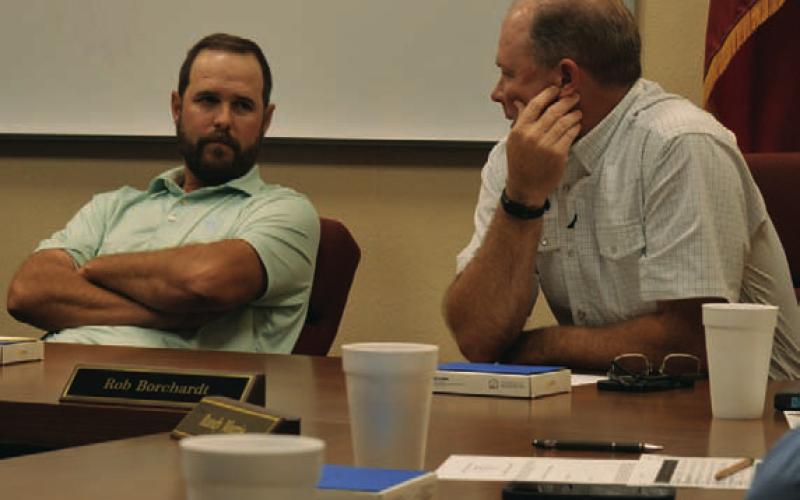 Trustees Ryan Shahan, left, and Rob Borchardt discuss options for a Lampasas ISD bond election that could go before voters in May. ERICK MITCHELL | DISPATCH RECORD