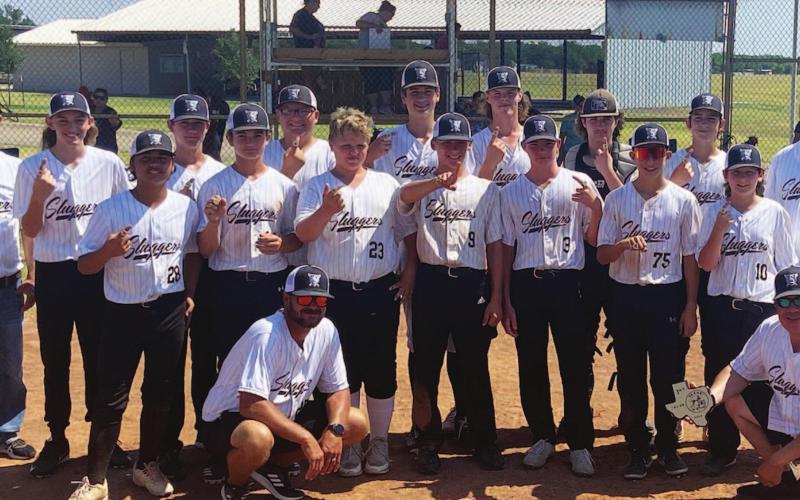 The Sluggers pose for a photo after winning district, and they will be on to the state tournament next week. COURTESY PHOTO