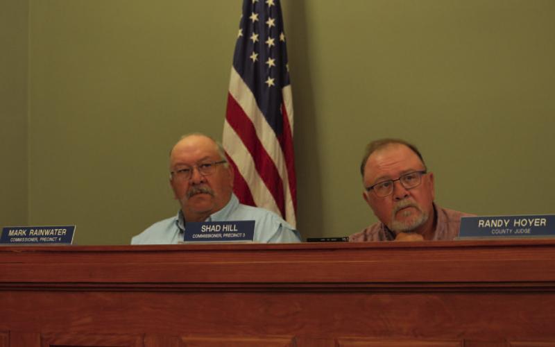 County Commissioners Mark Rainwater, left, and Shad Hill listen as the chief appraiser of the Lampasas Central Appraisal District outlines the proposed LCAD budget for 2026. ERICK MITCHELL | DISPATCH RECORD