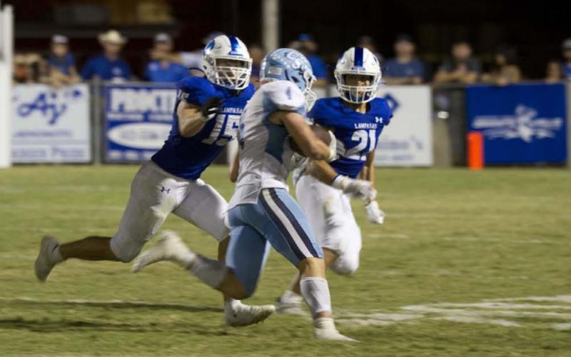Case Brister and Ethan Moreno pursue the China Spring runner during the matchup with the Cougars last Friday. HUNTER KING | DISPATCH RECORD