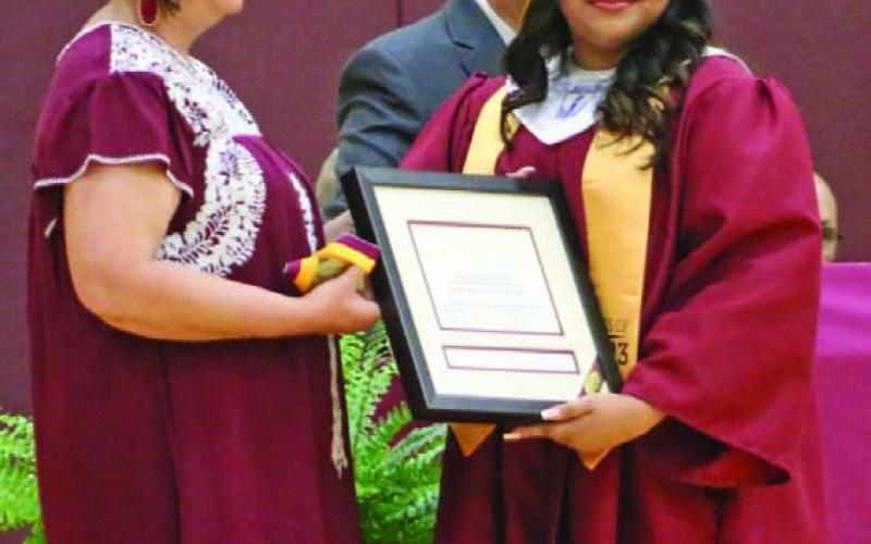 Principal Amanda Morris presents Veronica Padron with her Salutatorian award and medal. MASON HINES | DISPATCH RECORD