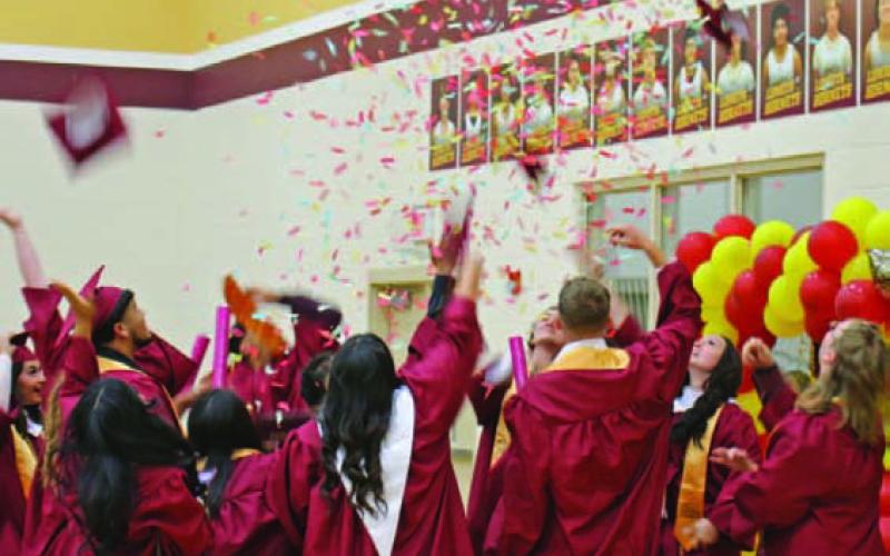 Students of the Lometa High School Class of 2023 celebrate by throwing their caps in the air. MASON HINES | DISPATCH RECORD