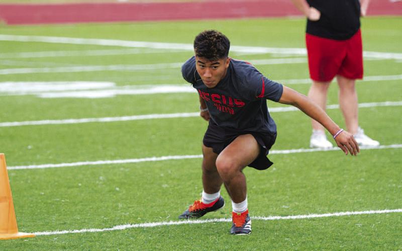 Juan Rodriguez runs through an agility drill at Tuesday’s SWAT workouts. HUNTER KING | DISPATCH RECORD