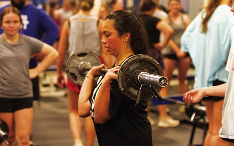 Johnnie Lewis lifts some weights during leg day for the Lady Badgers. HUNTER KING | DISPATCH RECORD
