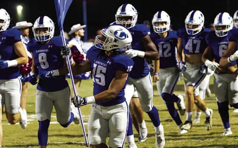 HUNTER KING | DISPATCH RECORD Dailan Fagan leads the Badgers onto the field before every game.