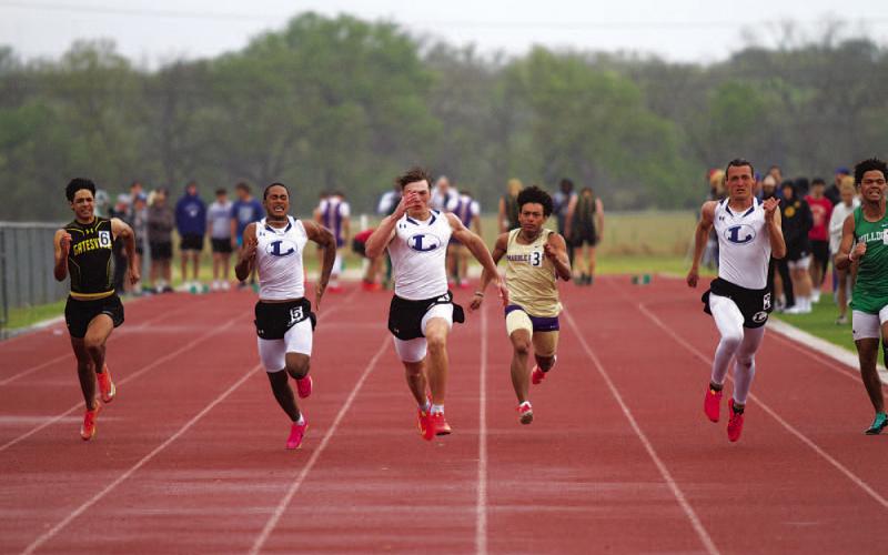 Wesley Stephens, left, Aaron Everts and Dacoda Fry sprint to the finish line in the 100-meter dash. HUNTER KING | DISPATCH RECORD