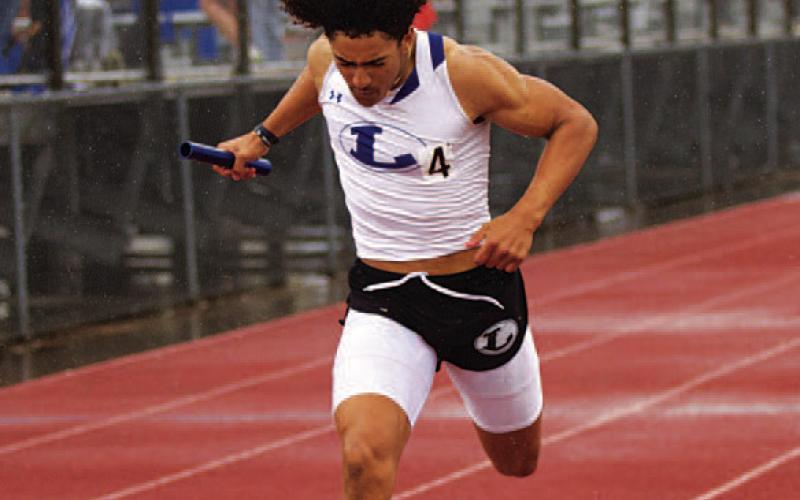 Ty Johnson finishes off the record-setting relay. HUNTER KING | DISPATCH RECORD