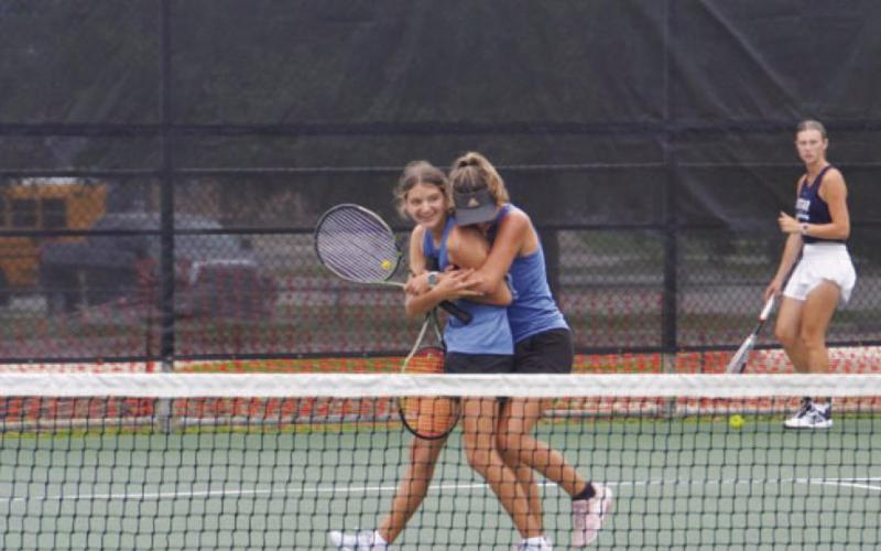 Madelynn White is hugged by her sister Caroline White after the duo won the regional tournament last week. COURTESY PHOTO | KENNETH PEISER