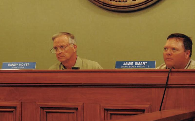 County Judge Randy Hoyer, left, and Commissioner Jamie Smart listen to discussion about changing language in the burn ban to permit the use of fireworks. HUNTER KING | DISPATCH RECORD